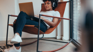 A developer sits in a rocking chair, with a computer