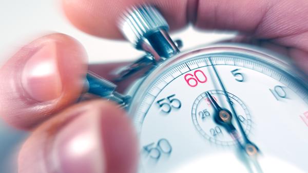 Close-up of a hand holding a stop watch timer