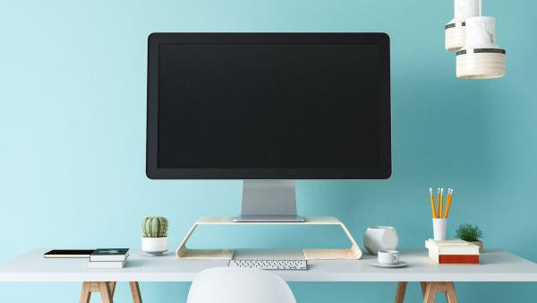 Computer on desk with blue background