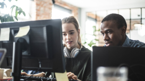 Two developers looking at a computer