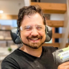 Christian Gerrard wears protective gear while woodworking in a workshop.