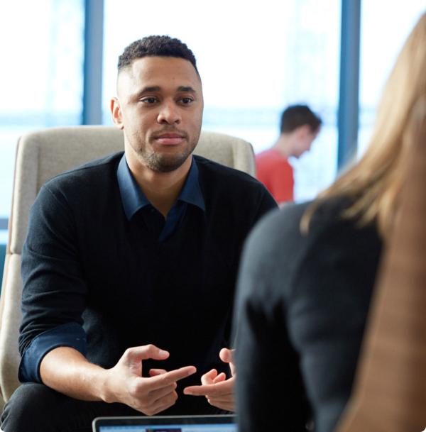 New Relic employee sitting and talking to another person