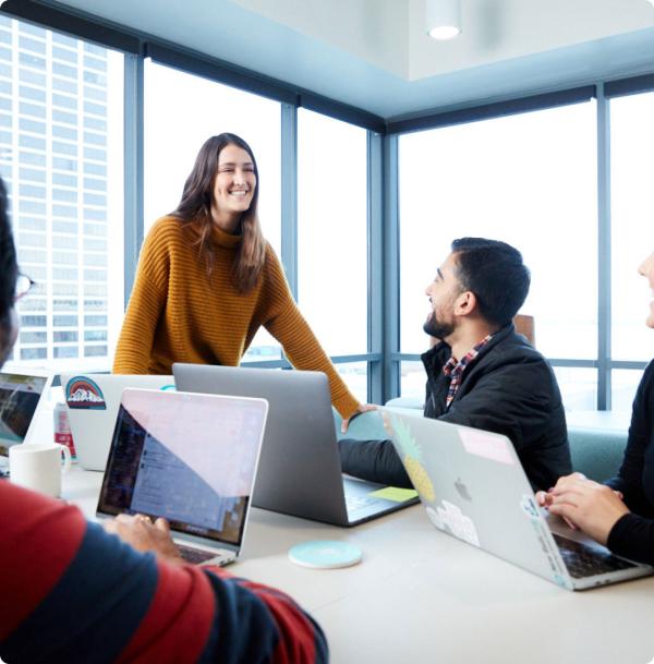 New Relic employees with laptops around a conference room table