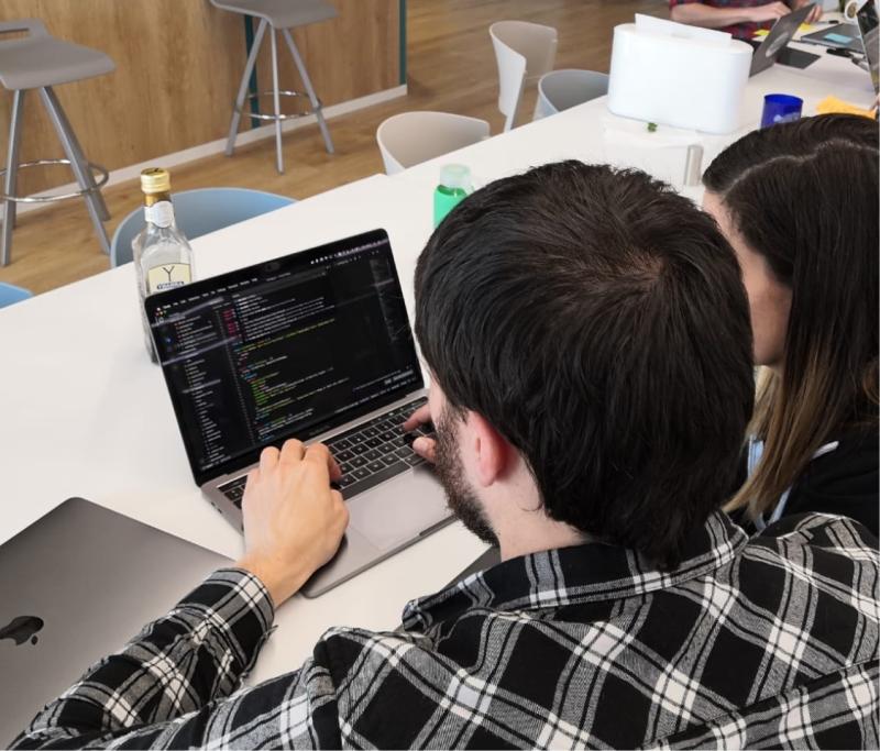 Person writing code on computer 