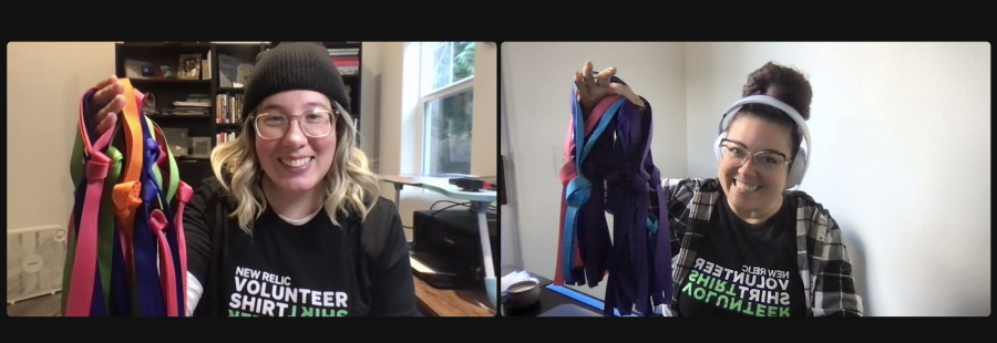 Web conference screenshot of two employees wearing New Relic Volunteer T-shirts, holding up ribbons to create drawstring bags for the Days for Girls nonprofit.